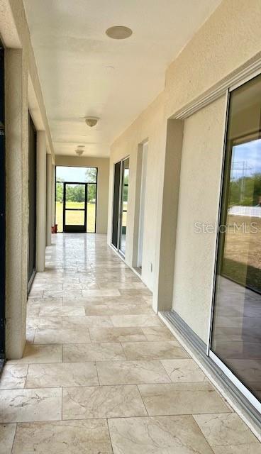 17127 Brown Rd, Odessa, FL 33556 - hallway with stone tile floors
