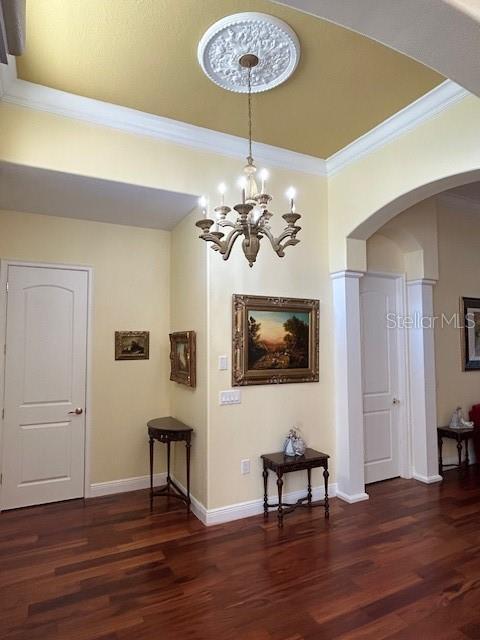 17127 Brown Rd, Odessa, FL 33556 - corridor with wood finished floors, arched walkways, ornamental molding, baseboards, and a chandelier
