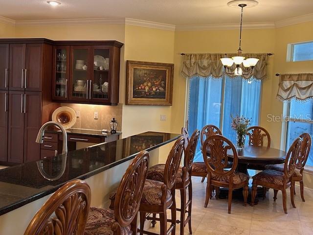 17127 Brown Rd, Odessa, FL 33556 - dining room with a chandelier and crown molding