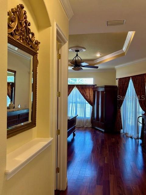 17127 Brown Rd, Odessa, FL 33556 - hall featuring a tray ceiling, hardwood / wood-style floors, and ornamental molding
