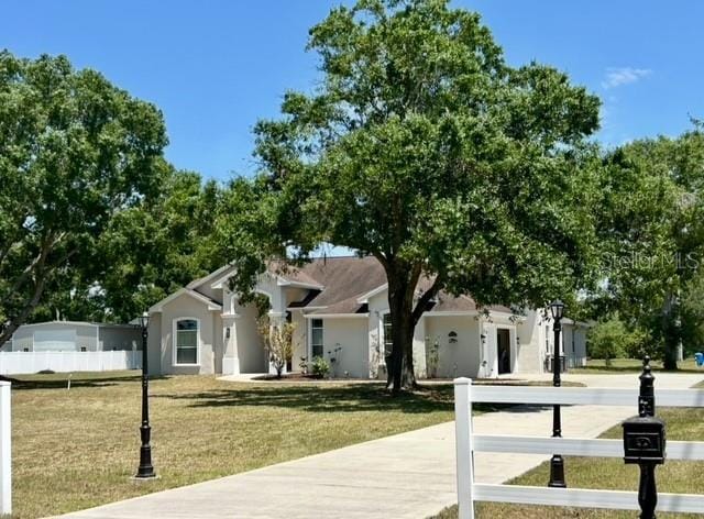 17127 Brown Rd, Odessa, FL 33556 - view of front of property with a front yard and stucco siding