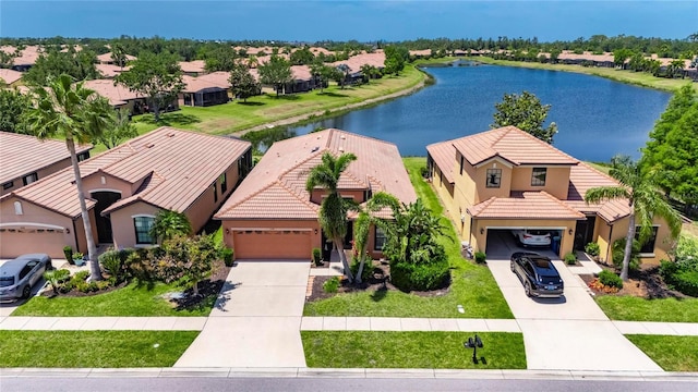 birds eye view of property with a residential view and a water view