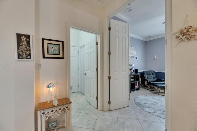 hallway with crown molding and light tile patterned flooring
