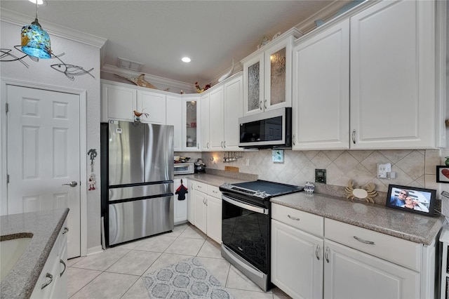 kitchen featuring ornamental molding, backsplash, white cabinets, and stainless steel appliances