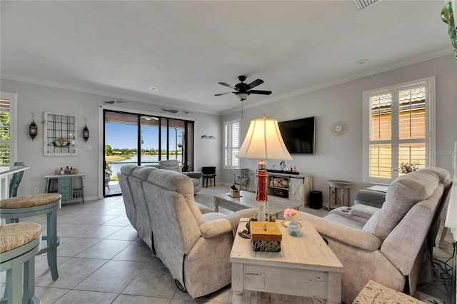 living room with crown molding, a ceiling fan, baseboards, and light tile patterned floors