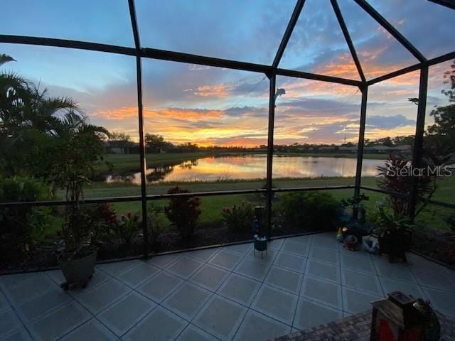unfurnished sunroom with a water view