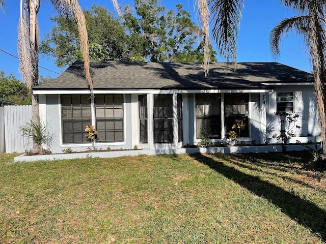 321 David Ave, Clearwater, FL 33759 - view of front of property featuring fence, a front yard, and stucco siding