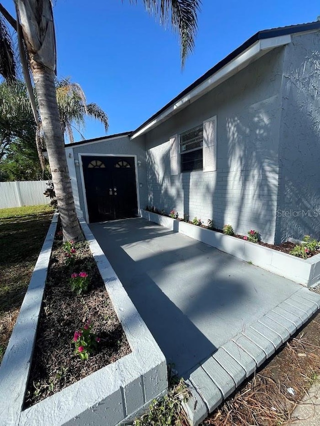 321 David Ave, Clearwater, FL 33759 - view of side of home with stucco siding and fence