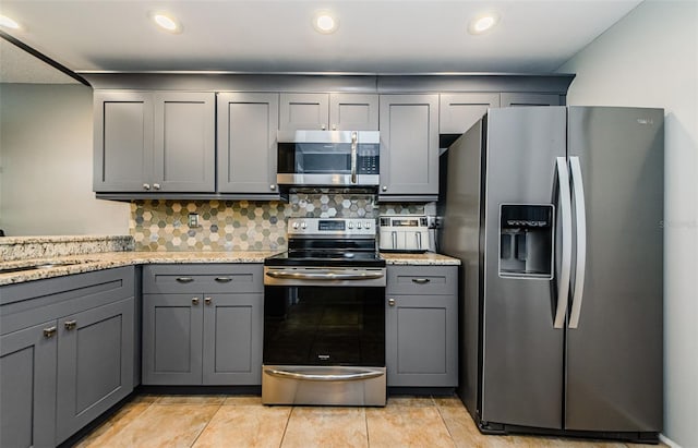 124 Nina Way Unit 24, Oldsmar, FL 34677 - kitchen with stainless steel appliances, gray cabinetry, decorative backsplash, a sink, and recessed lighting