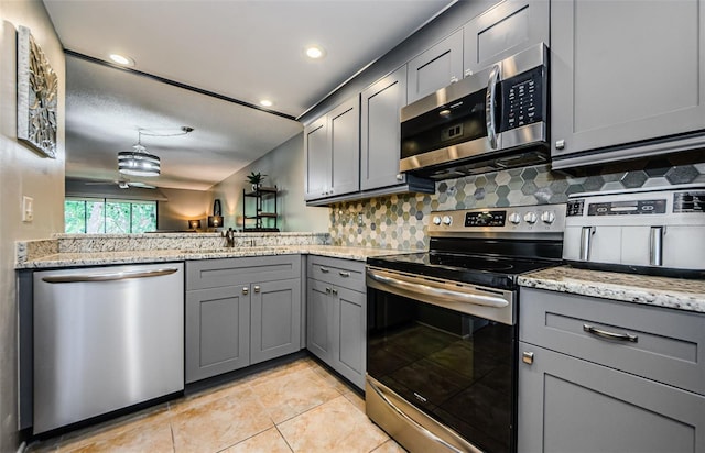 124 Nina Way Unit 24, Oldsmar, FL 34677 - kitchen featuring stainless steel appliances, gray cabinetry, a sink, light tile patterned floors, and recessed lighting