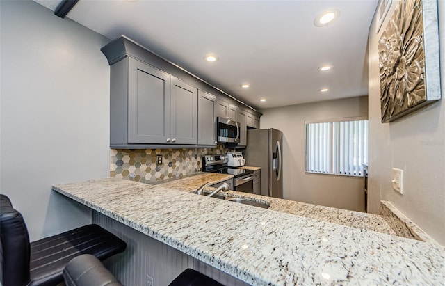 124 Nina Way Unit 24, Oldsmar, FL 34677 - kitchen with stainless steel appliances, backsplash, recessed lighting, gray cabinets, and a sink