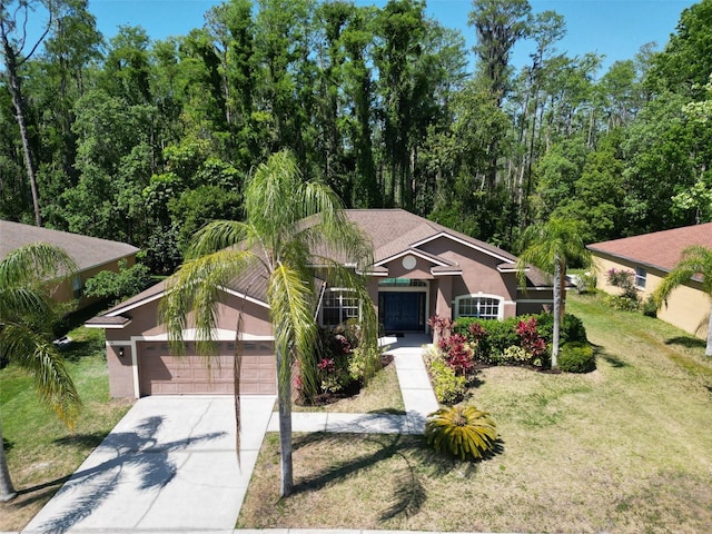 1135 Wyndham Lakes Dr, Odessa, FL 33556 - view of front of house featuring stucco siding, an attached garage, driveway, and a front lawn
