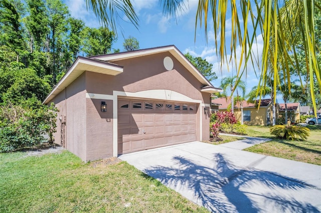 1135 Wyndham Lakes Dr, Odessa, FL 33556 - view of home's exterior with a garage, driveway, stucco siding, and a lawn