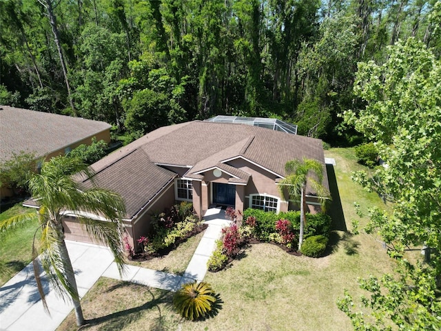 1135 Wyndham Lakes Dr, Odessa, FL 33556 - view of front of home featuring stucco siding, an attached garage, concrete driveway, and a front lawn