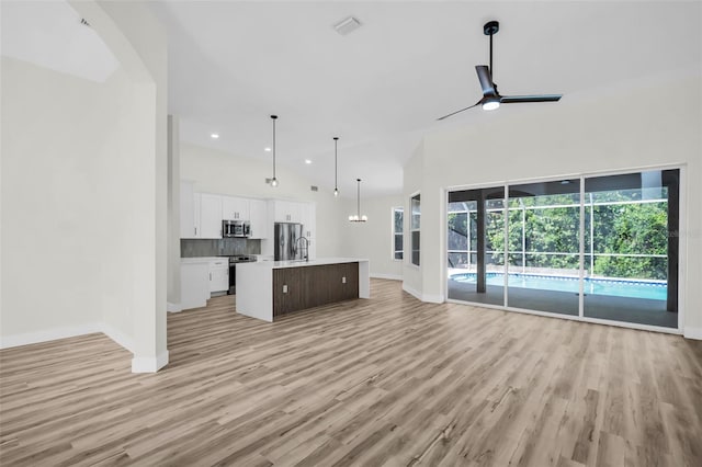 1135 Wyndham Lakes Dr, Odessa, FL 33556 - unfurnished living room with recessed lighting, light wood finished floors, visible vents, a ceiling fan, and baseboards