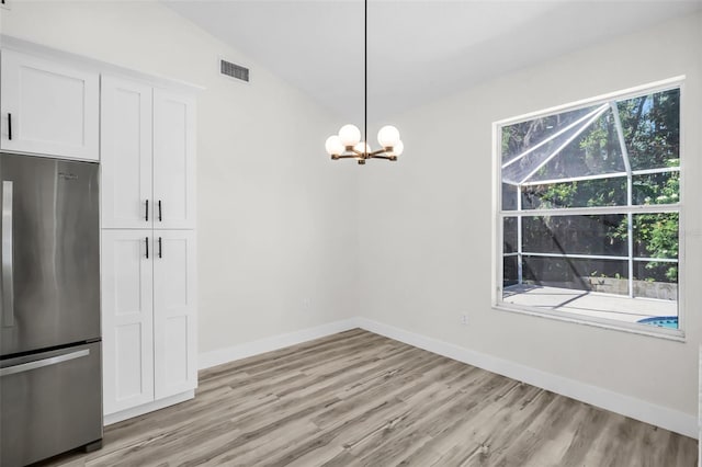 1135 Wyndham Lakes Dr, Odessa, FL 33556 - unfurnished dining area with light wood-type flooring, baseboards, visible vents, and an inviting chandelier
