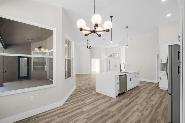 1135 Wyndham Lakes Dr, Odessa, FL 33556 - kitchen featuring open floor plan, stainless steel appliances, light wood finished floors, and a sink