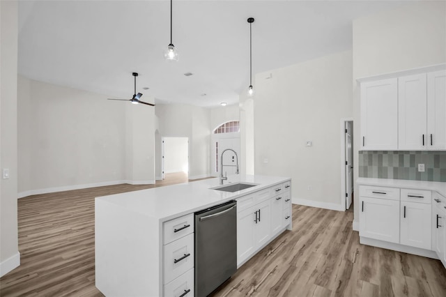 1135 Wyndham Lakes Dr, Odessa, FL 33556 - kitchen with stainless steel dishwasher, light wood-style floors, and light countertops
