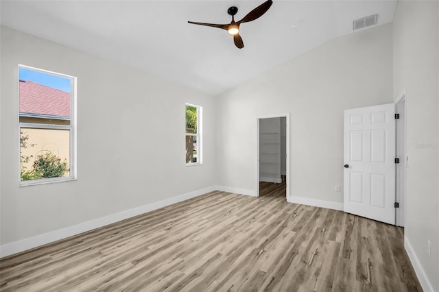 1135 Wyndham Lakes Dr, Odessa, FL 33556 - unfurnished bedroom featuring wood finished floors, visible vents, a ceiling fan, baseboards, and high vaulted ceiling