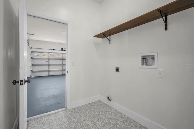 1135 Wyndham Lakes Dr, Odessa, FL 33556 - clothes washing area with baseboards, washer hookup, a garage, electric dryer hookup, and laundry area