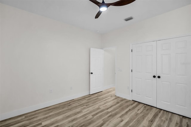 1135 Wyndham Lakes Dr, Odessa, FL 33556 - unfurnished bedroom with a closet, light wood-type flooring, ceiling fan, baseboards, and visible vents