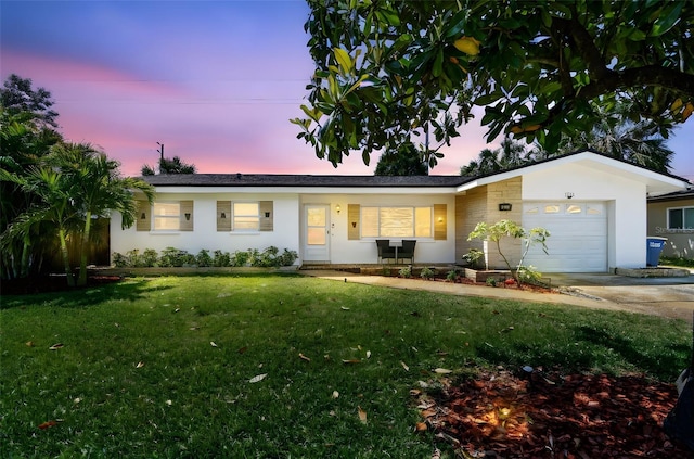 1751 Ashton Abbey Rd, Clearwater, FL 33755 - single story home with an attached garage, a lawn, concrete driveway, and stucco siding