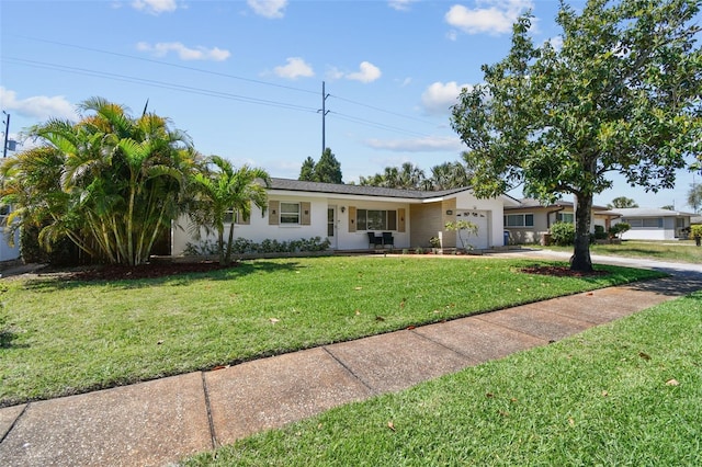 1751 Ashton Abbey Rd, Clearwater, FL 33755 - ranch-style home with an attached garage, concrete driveway, a front yard, and stucco siding