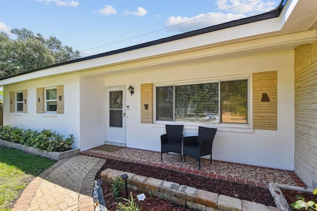 1751 Ashton Abbey Rd, Clearwater, FL 33755 - doorway to property featuring stucco siding and covered porch