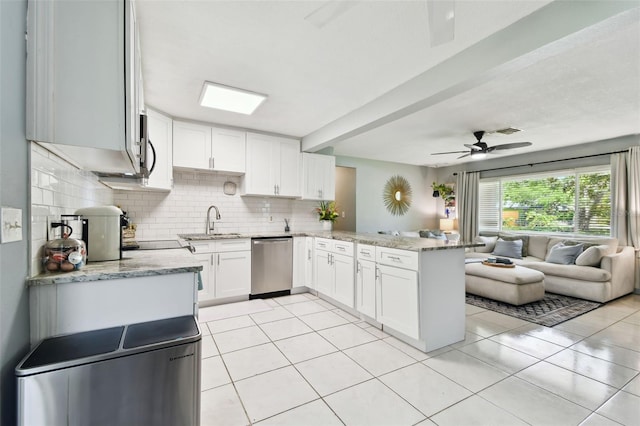1751 Ashton Abbey Rd, Clearwater, FL 33755 - kitchen featuring dishwasher, open floor plan, a peninsula, decorative backsplash, and ceiling fan