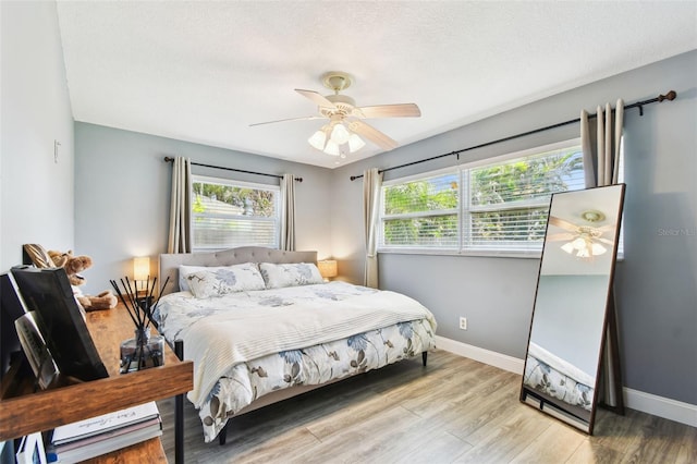 1751 Ashton Abbey Rd, Clearwater, FL 33755 - bedroom featuring wood finished floors, ceiling fan, and a textured ceiling