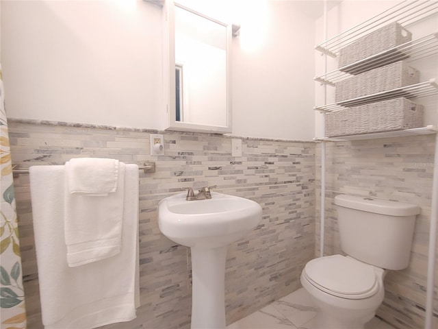 1751 Ashton Abbey Rd, Clearwater, FL 33755 - full bath with tile walls, a wainscoted wall, and marble finish floors
