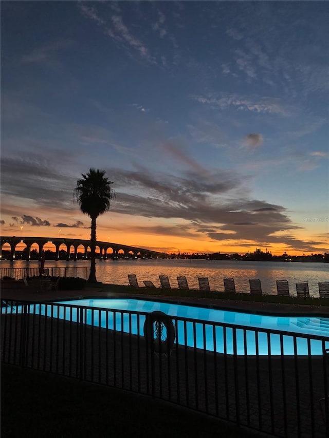 6279 Sun Blvd Unit 103, Saint Petersburg, FL 33715 - pool at dusk featuring a fenced in pool and a water view