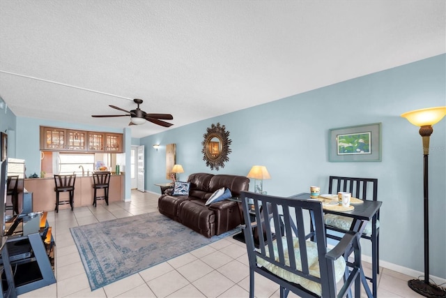 6279 Sun Blvd Unit 103, Saint Petersburg, FL 33715 - living room featuring a ceiling fan, baseboards, and light tile patterned floors