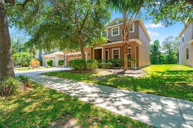 10617 Lucaya Dr, Tampa, FL 33647 - view of front facade featuring a front lawn, an attached garage, concrete driveway, and stucco siding