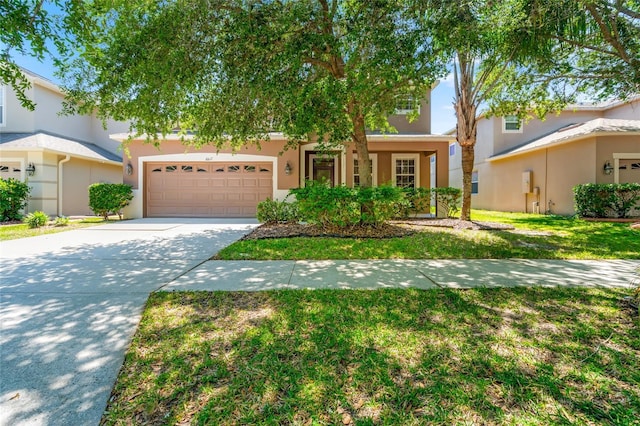 10617 Lucaya Dr, Tampa, FL 33647 - view of front of property featuring an attached garage, driveway, a front yard, and stucco siding