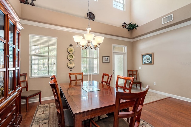 10617 Lucaya Dr, Tampa, FL 33647 - dining space featuring a notable chandelier, visible vents, a wealth of natural light, and dark wood-type flooring