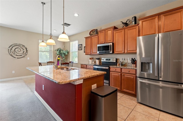 10617 Lucaya Dr, Tampa, FL 33647 - kitchen with stainless steel appliances, visible vents, a sink, a center island with sink, and brown cabinetry