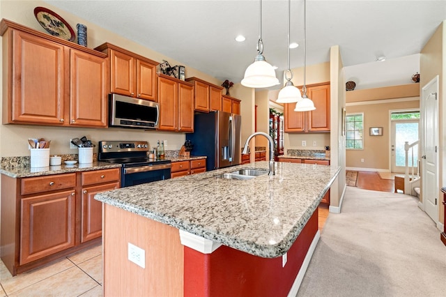 10617 Lucaya Dr, Tampa, FL 33647 - kitchen with stainless steel appliances, a kitchen island with sink, a sink, and light stone counters