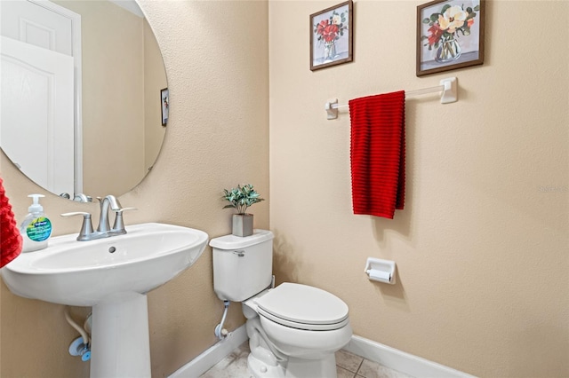 10617 Lucaya Dr, Tampa, FL 33647 - half bath with baseboards, tile patterned flooring, a sink, and toilet