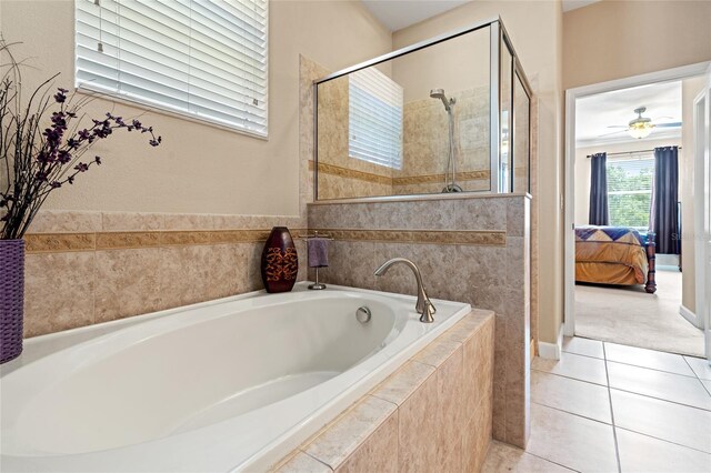 10617 Lucaya Dr, Tampa, FL 33647 - ensuite bathroom with tile patterned flooring, connected bathroom, a bath, a stall shower, and ceiling fan