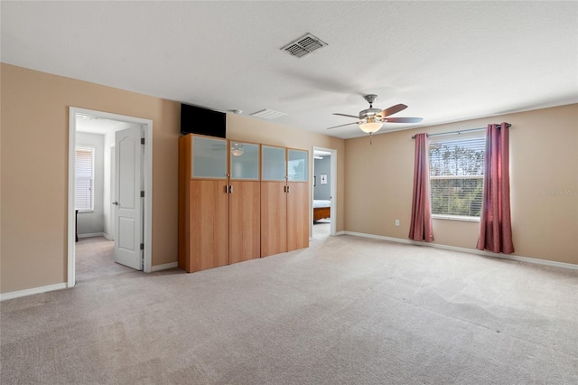 10617 Lucaya Dr, Tampa, FL 33647 - unfurnished bedroom featuring light carpet, baseboards, visible vents, and a ceiling fan