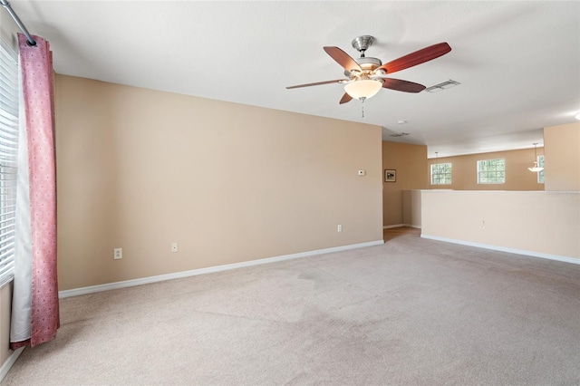 10617 Lucaya Dr, Tampa, FL 33647 - unfurnished room featuring light colored carpet, baseboards, a ceiling fan, and visible vents