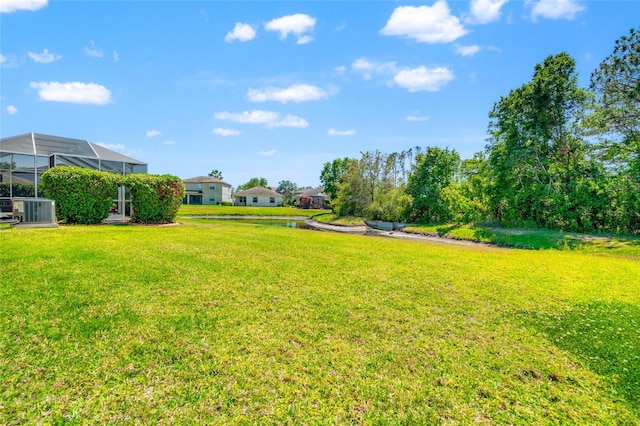 10617 Lucaya Dr, Tampa, FL 33647 - view of yard with central AC and glass enclosure