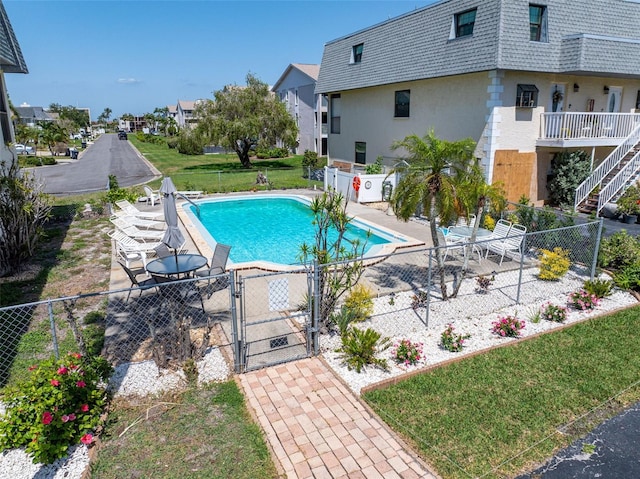12485 2nd St E Unit C103, Treasure Island, FL 33706 - view of pool with a gate, fence, and a patio area