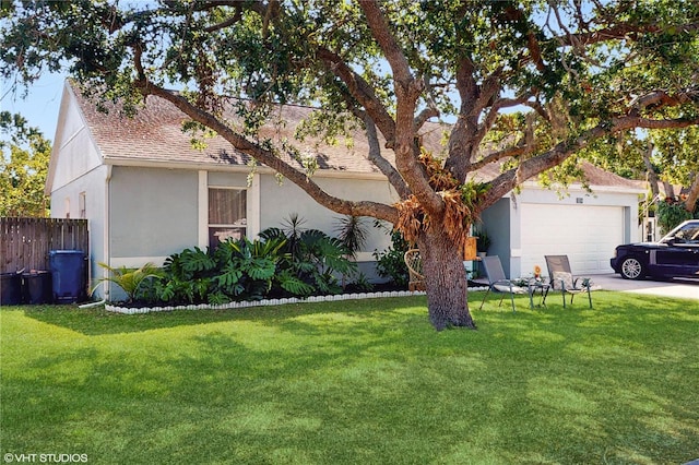 view of front of property featuring fence, a garage, stucco siding, a shingled roof, and a front lawn