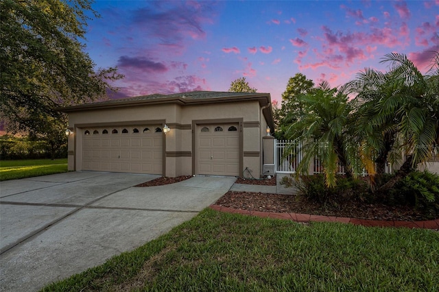 7519 Berna Ln, Land O Lakes, FL 34637 - view of front of home featuring concrete driveway, stucco siding, an attached garage, and a front yard