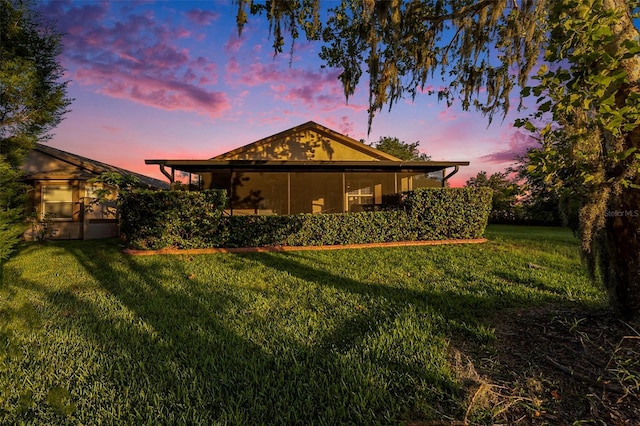 7519 Berna Ln, Land O Lakes, FL 34637 - rear view of property featuring a lawn and a sunroom
