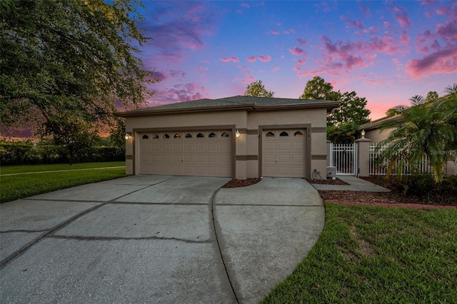 7519 Berna Ln, Land O Lakes, FL 34637 - view of front facade featuring stucco siding, concrete driveway, a garage, and a gate