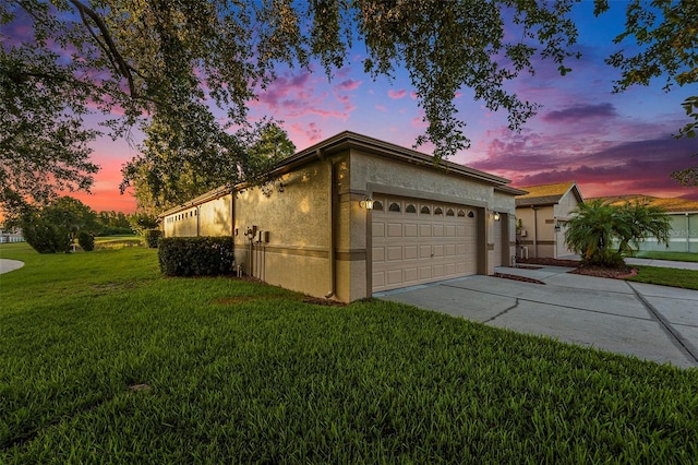 7519 Berna Ln, Land O Lakes, FL 34637 - view of front of house with a garage, a front yard, stucco siding, and driveway