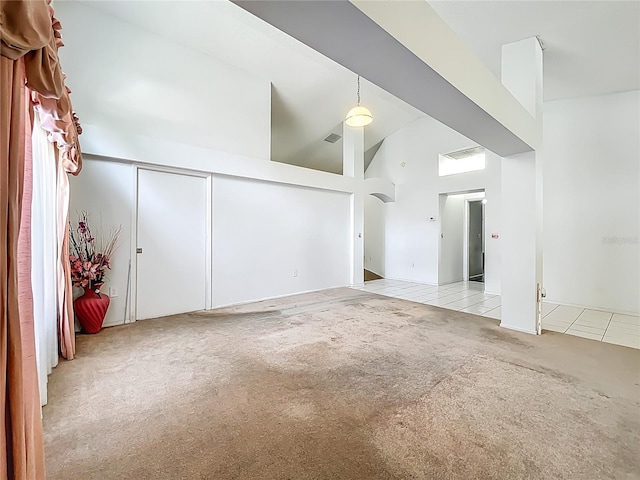 11216 Longbrooke Dr, Riverview, FL 33579 - carpeted empty room featuring tile patterned flooring and high vaulted ceiling